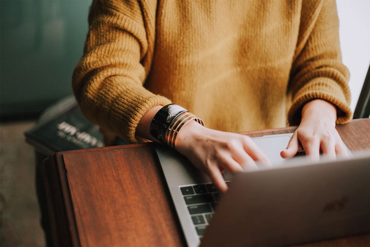 Person typing on laptop. Close-up view.