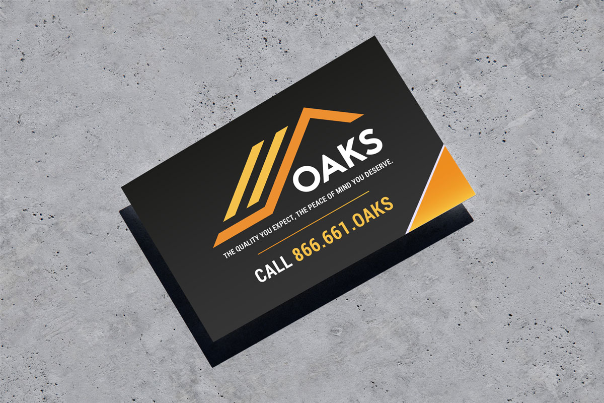 Oaks construction company business card on gray background