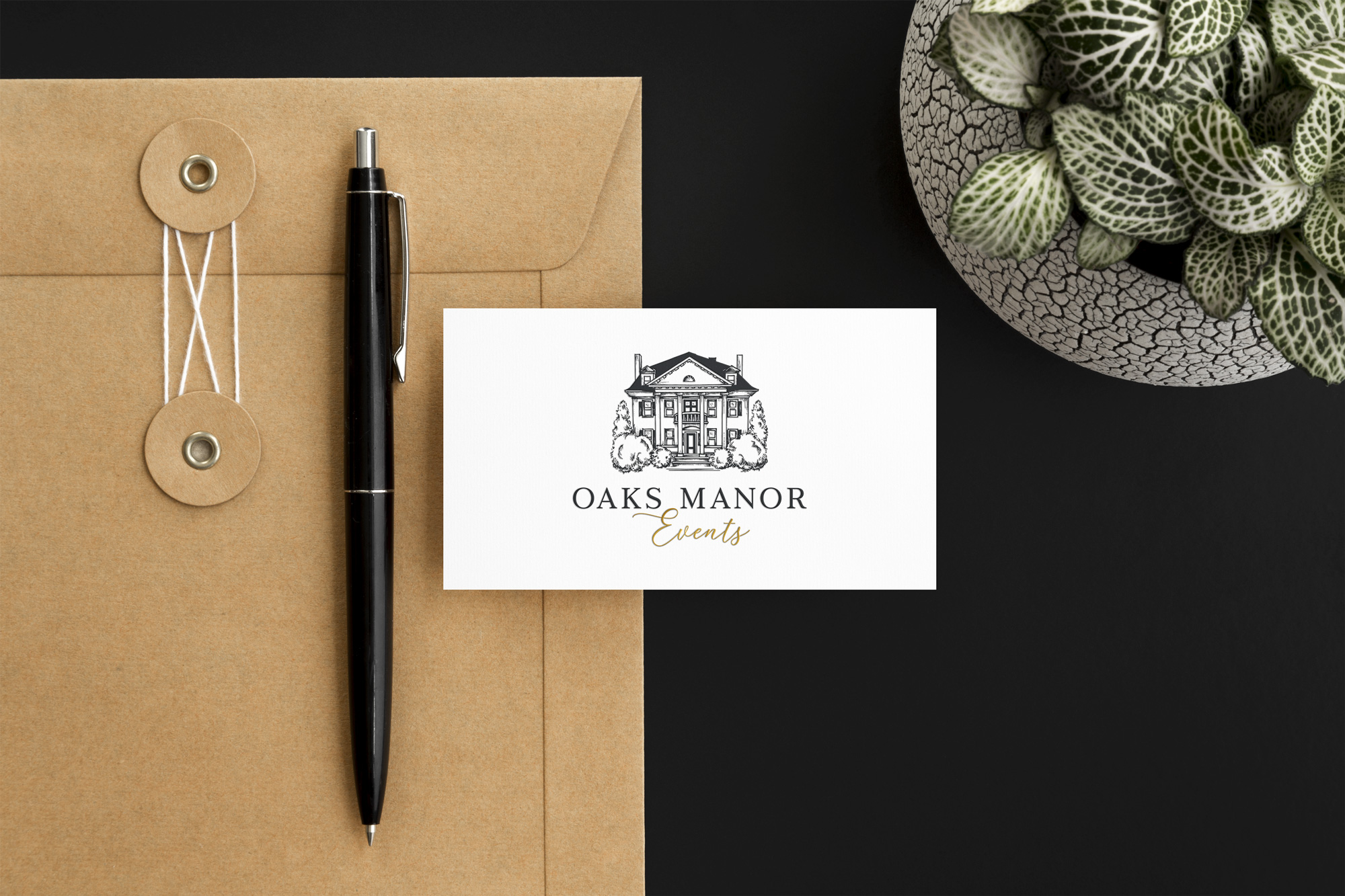 Oaks Manor wedding venue logo on a business card